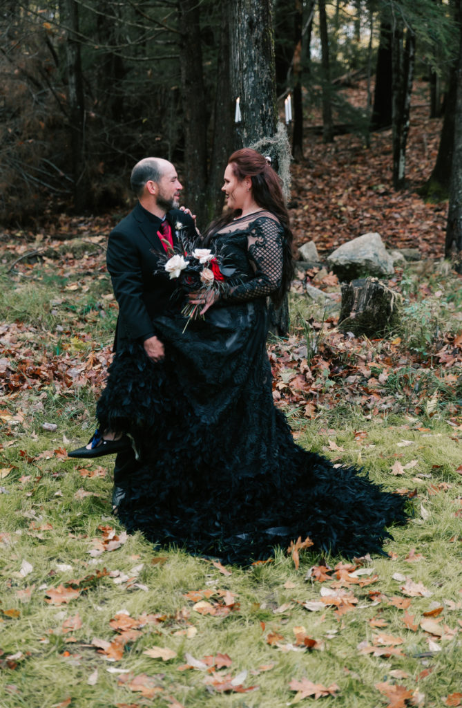 groom and bride in black wedding attire, with bride wearing a dramatic black dress