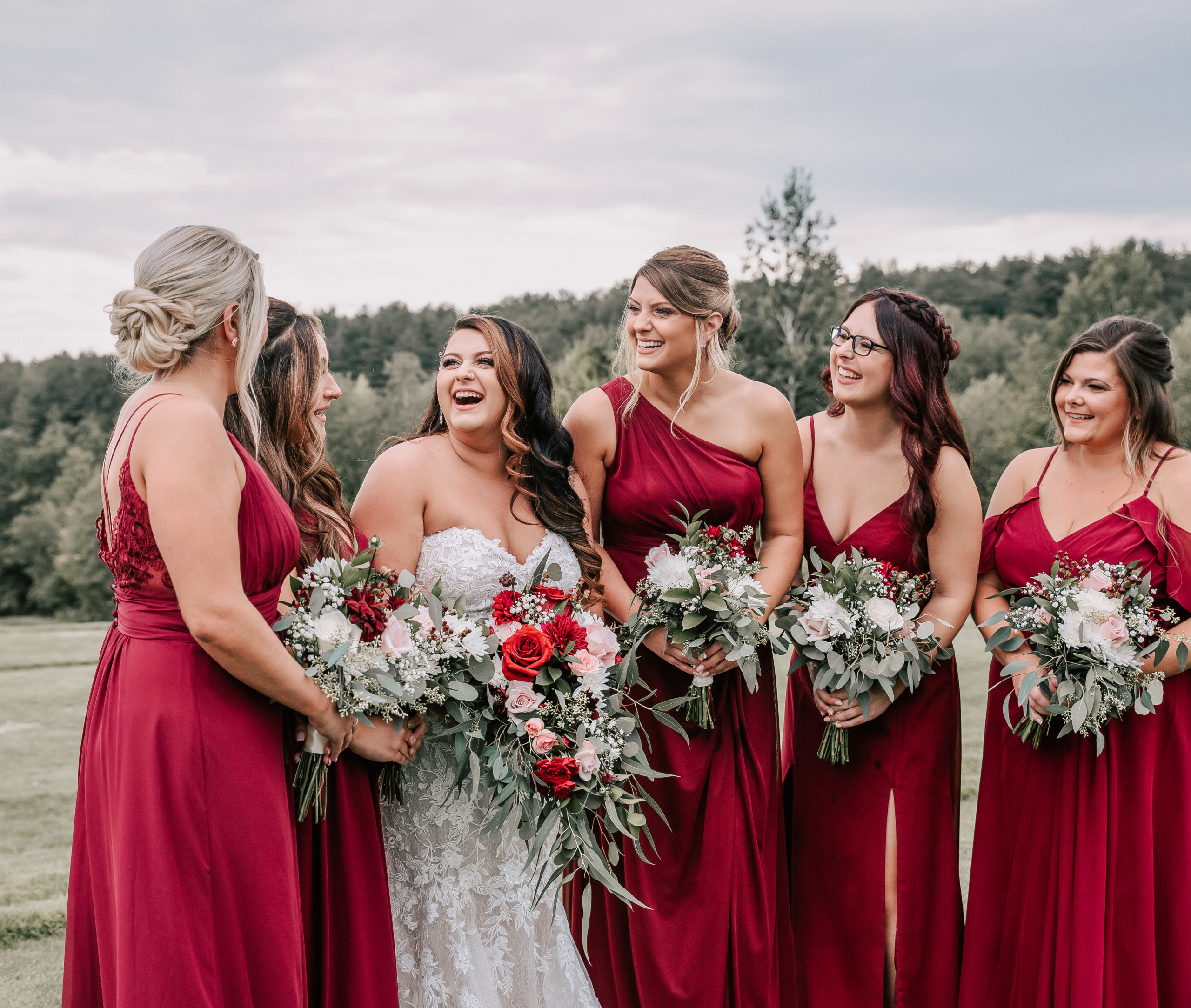 bride and bridesmaids laughing together at new hampshire wedding - by Vivid Instincts Photography, a New England wedding photographer