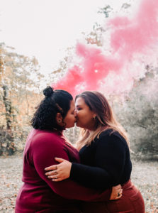 lesbian couple taking engagement photos with smoke bomb in Massachusetts