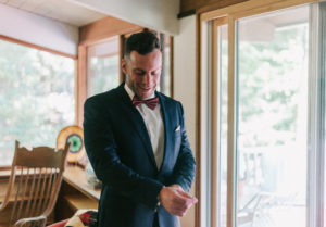 groom getting ready at lakeside wedding venue in New Hampshire