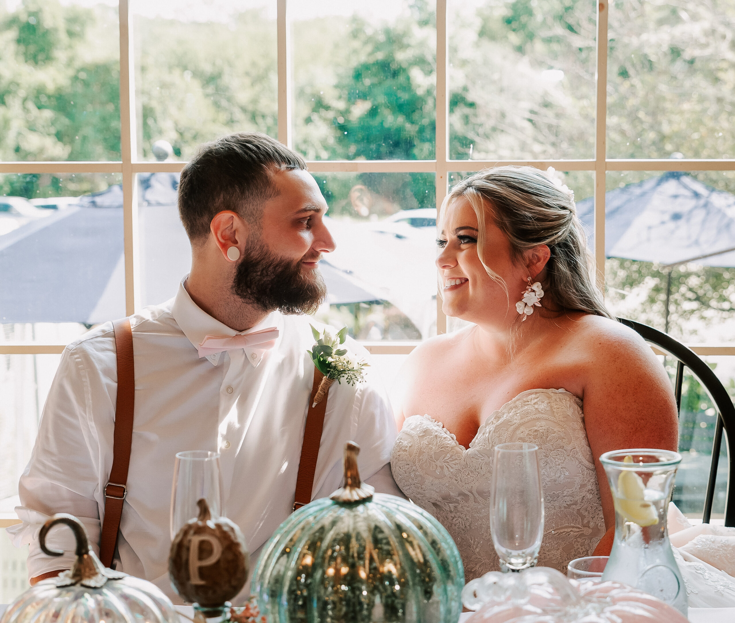 couple sitting at sweetheart table on their wedding day at Bittersweet Farm