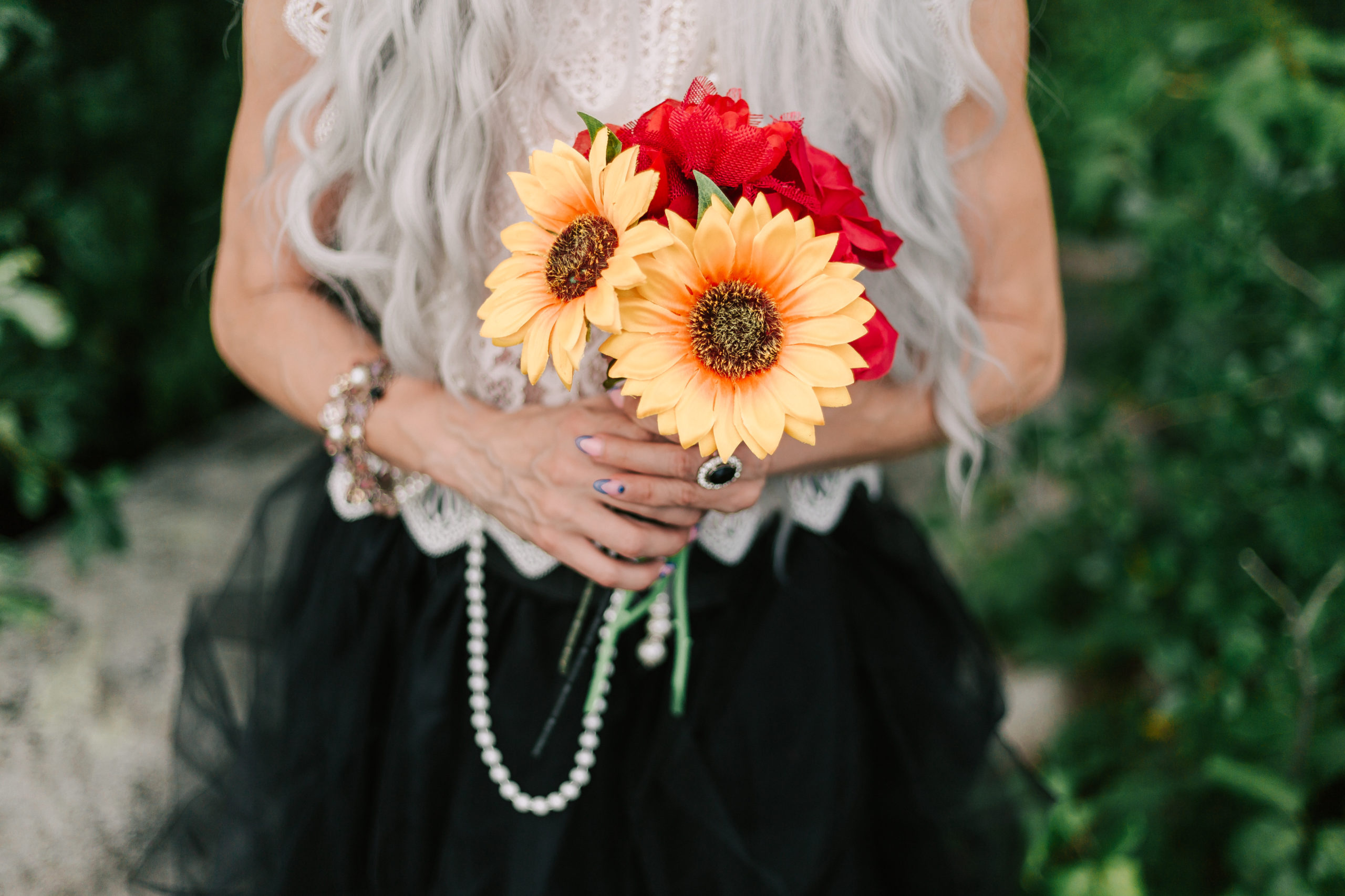 alternative bride holding a sunflower bouquet at a Friendly Crossways wedding