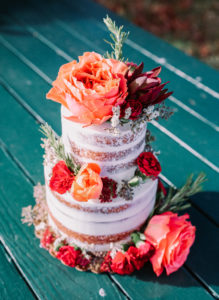 semi-naked wedding cake with bright flowers by Ellie's Bakery in Providence, RI