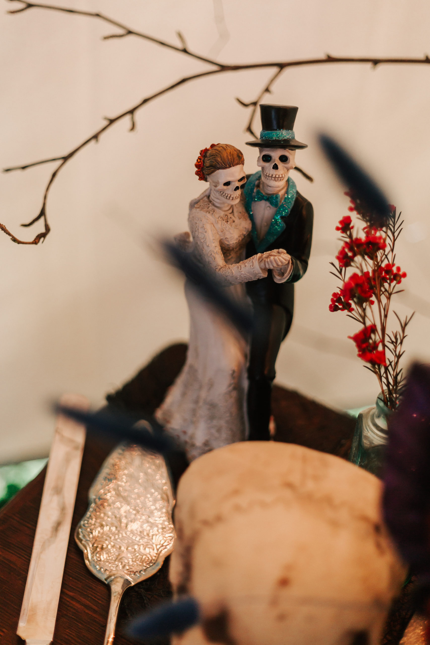 cute skeleton wedding cake topper at a Halloween Salem Massachusetts wedding, captured by Vivid Instincts Photography