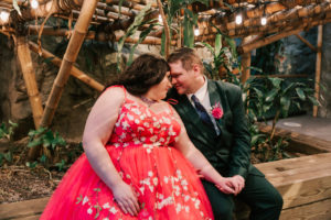 couple posing for photos at their wedding in the Tropical Forest of the Franklin Park Zoo