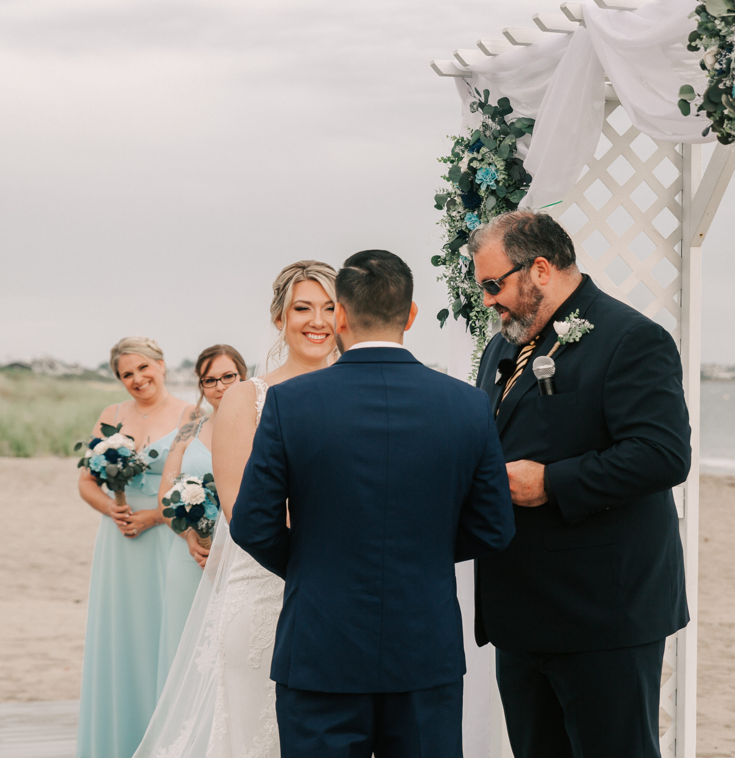 a couple getting married on the beach at Galilee Beach Club in Narragansett, RI - one of the most unique wedding venues in Rhode Island