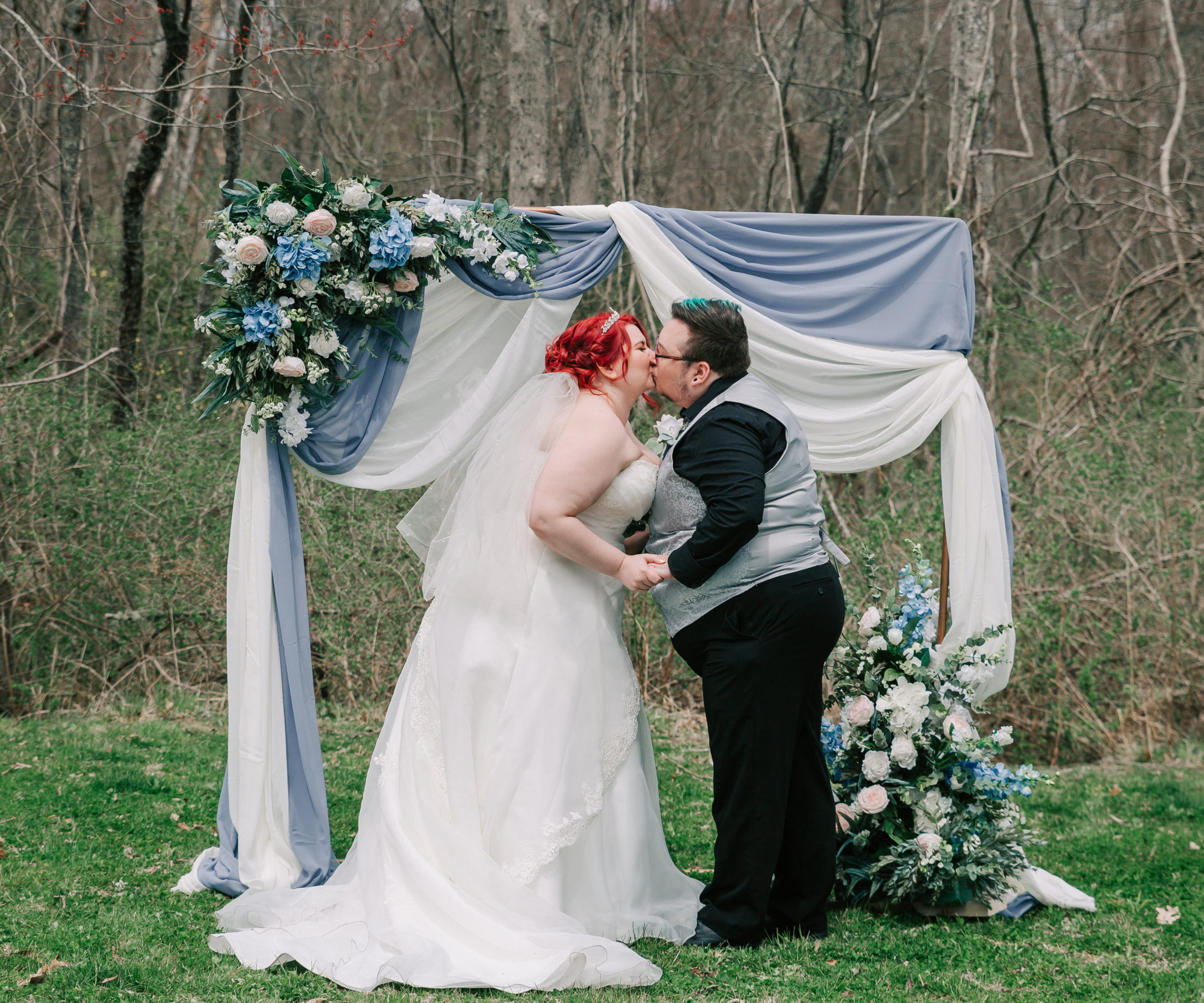 bride and groom kissing during backyard wedding ceremony planned by Events by Amy Melody, one of many talented Boston wedding planners