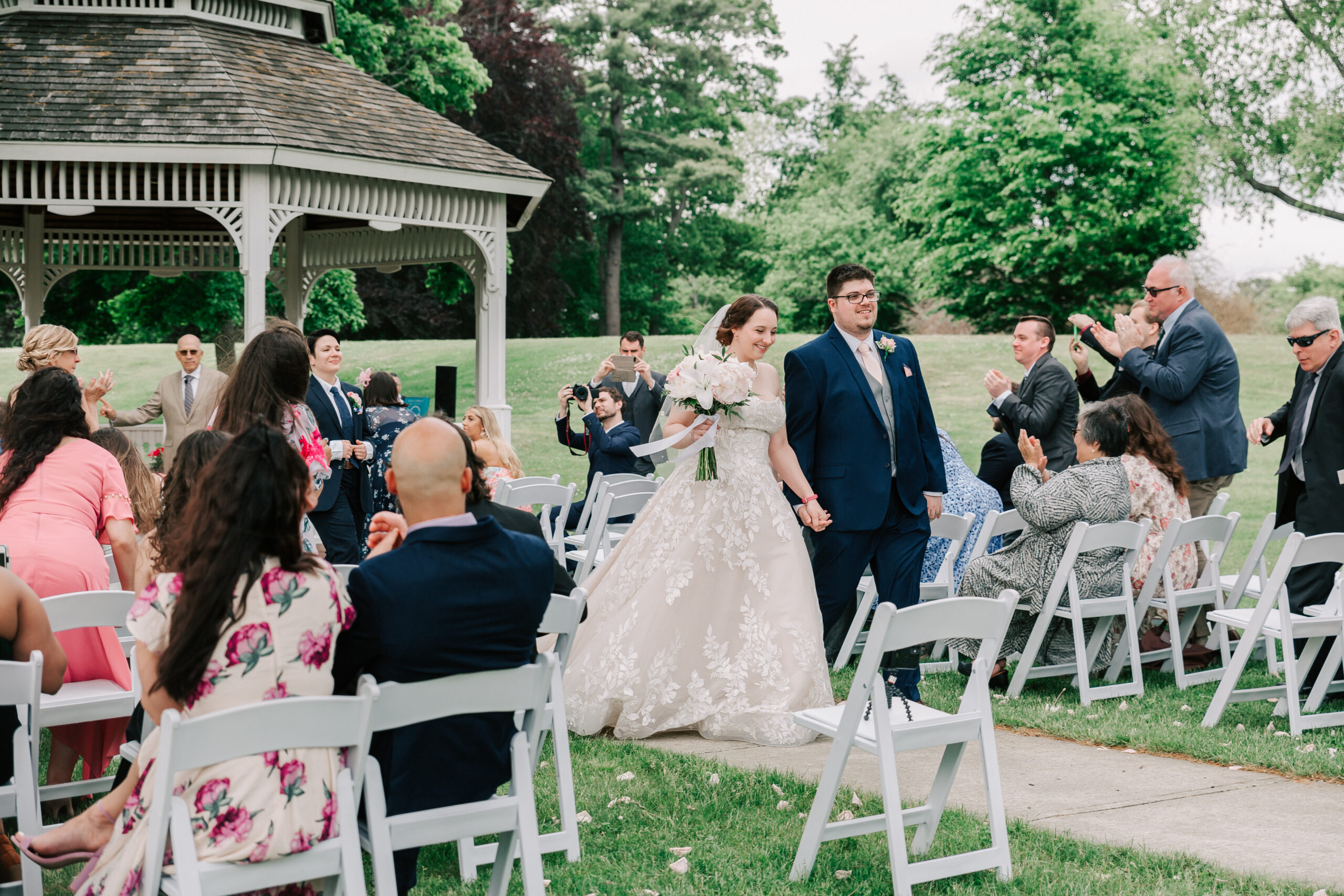newlywed couple walking back down the aisle after getting married at the gazebo at Endicott Estate, a historic wedding venue in Massachusetts