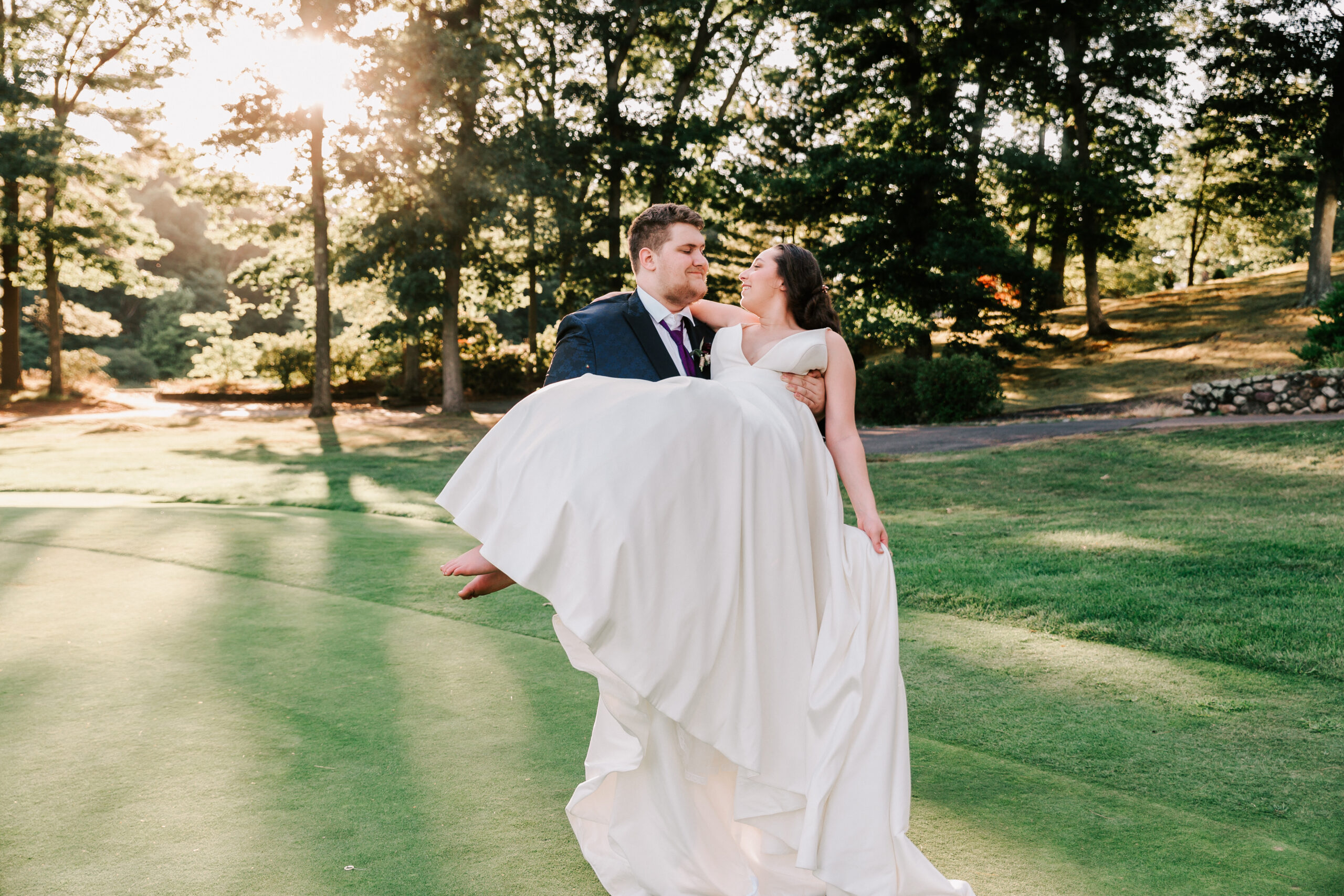 groom holding bride wearing a dress from Alexandra's Boutique, a boston area wedding dress shop