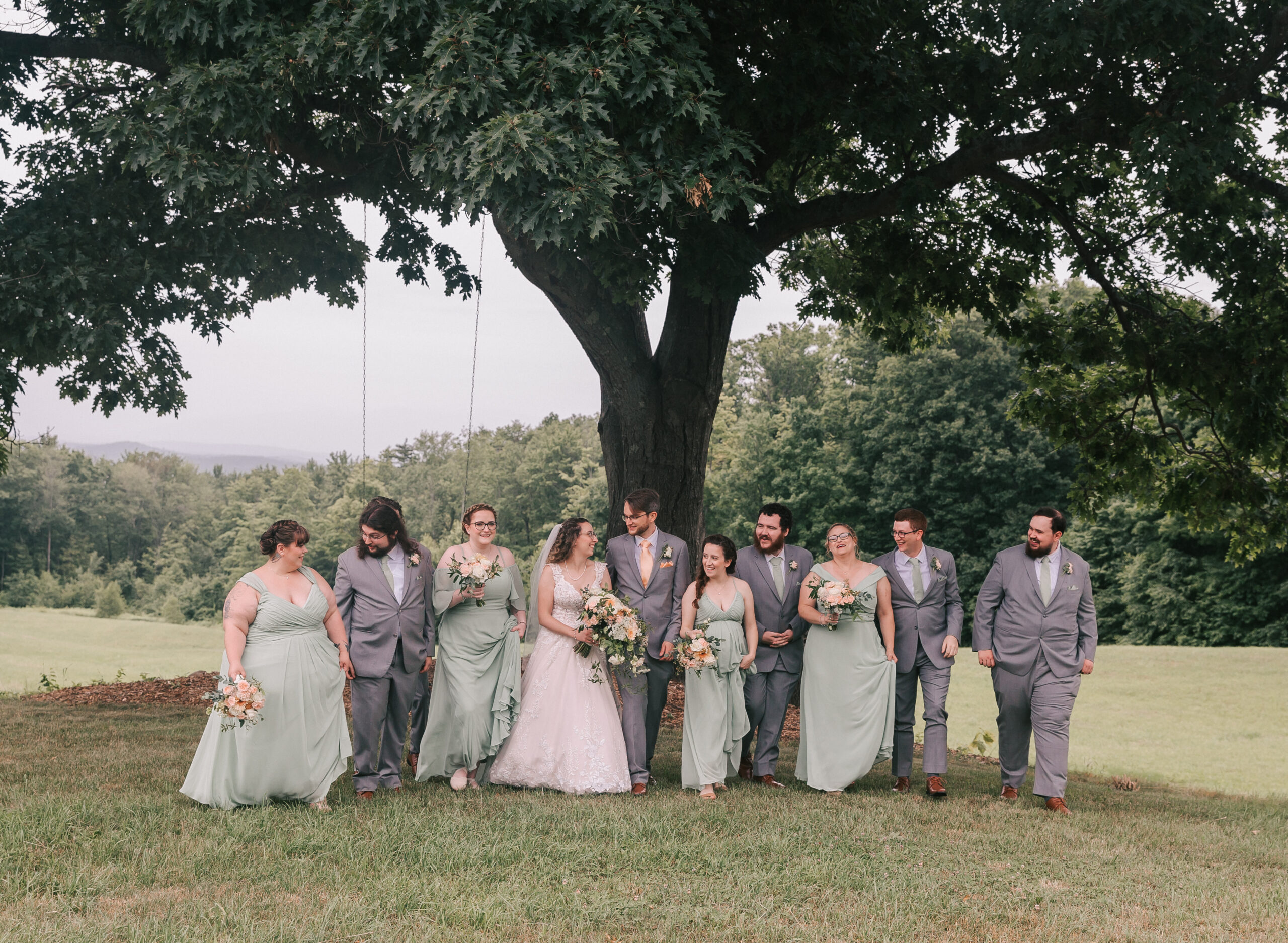 wedding party walking through meadow at Timber Hill Farm, one of the best White Mountains wedding venues