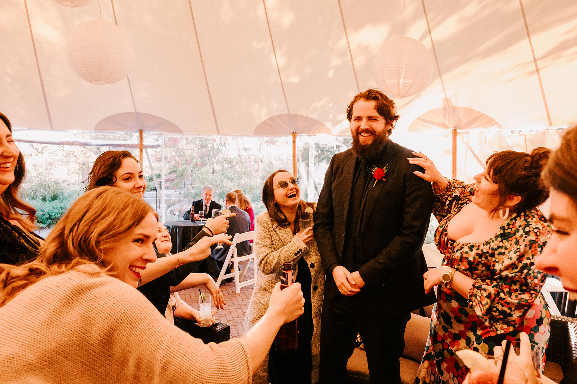 guests laughing and enjoying cocktail hour under the Sperry Tent at a Harrington Farm wedding