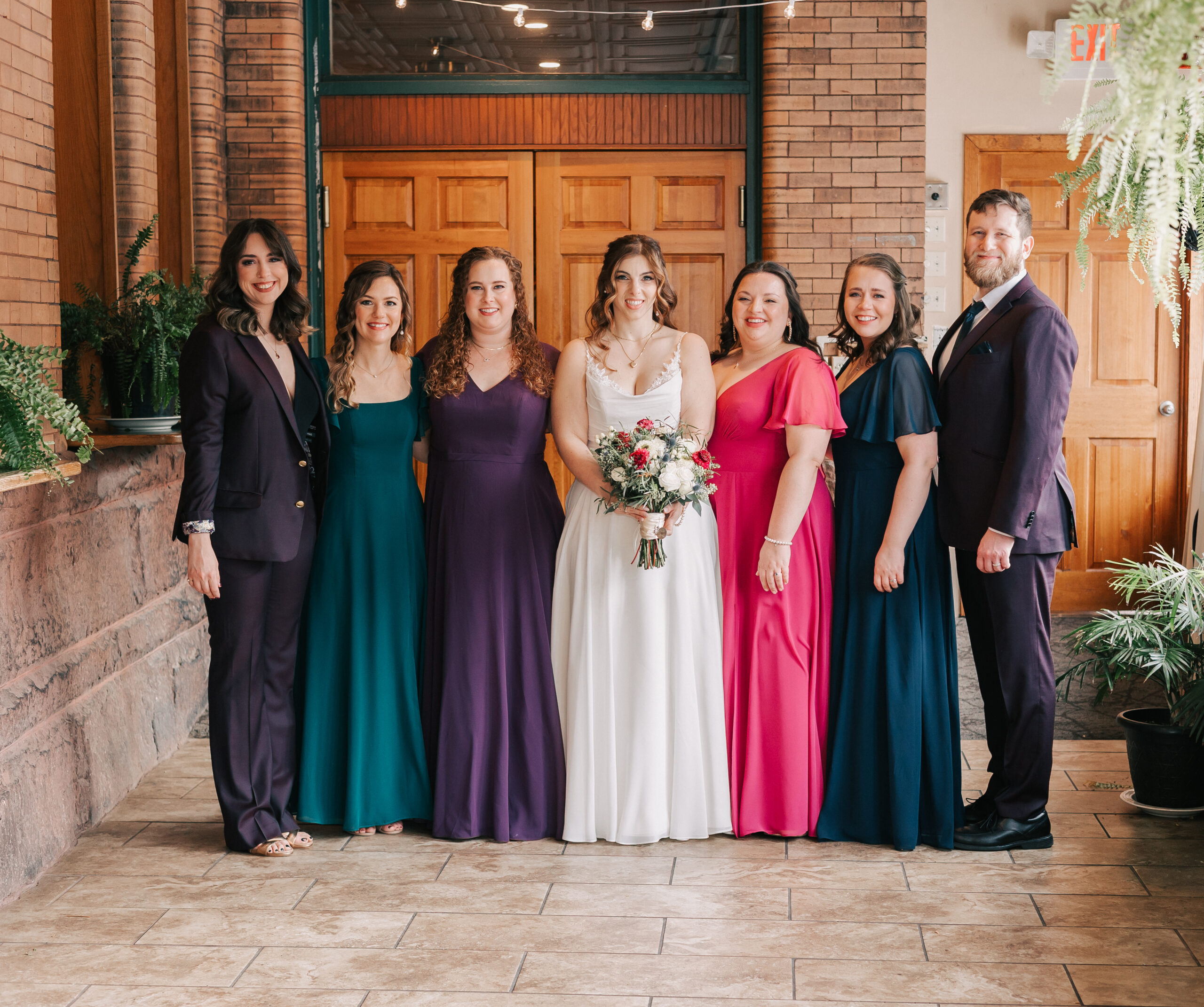 Bride and wedding party posing at queer wedding at Union Station, one of the best Western MA wedding venues