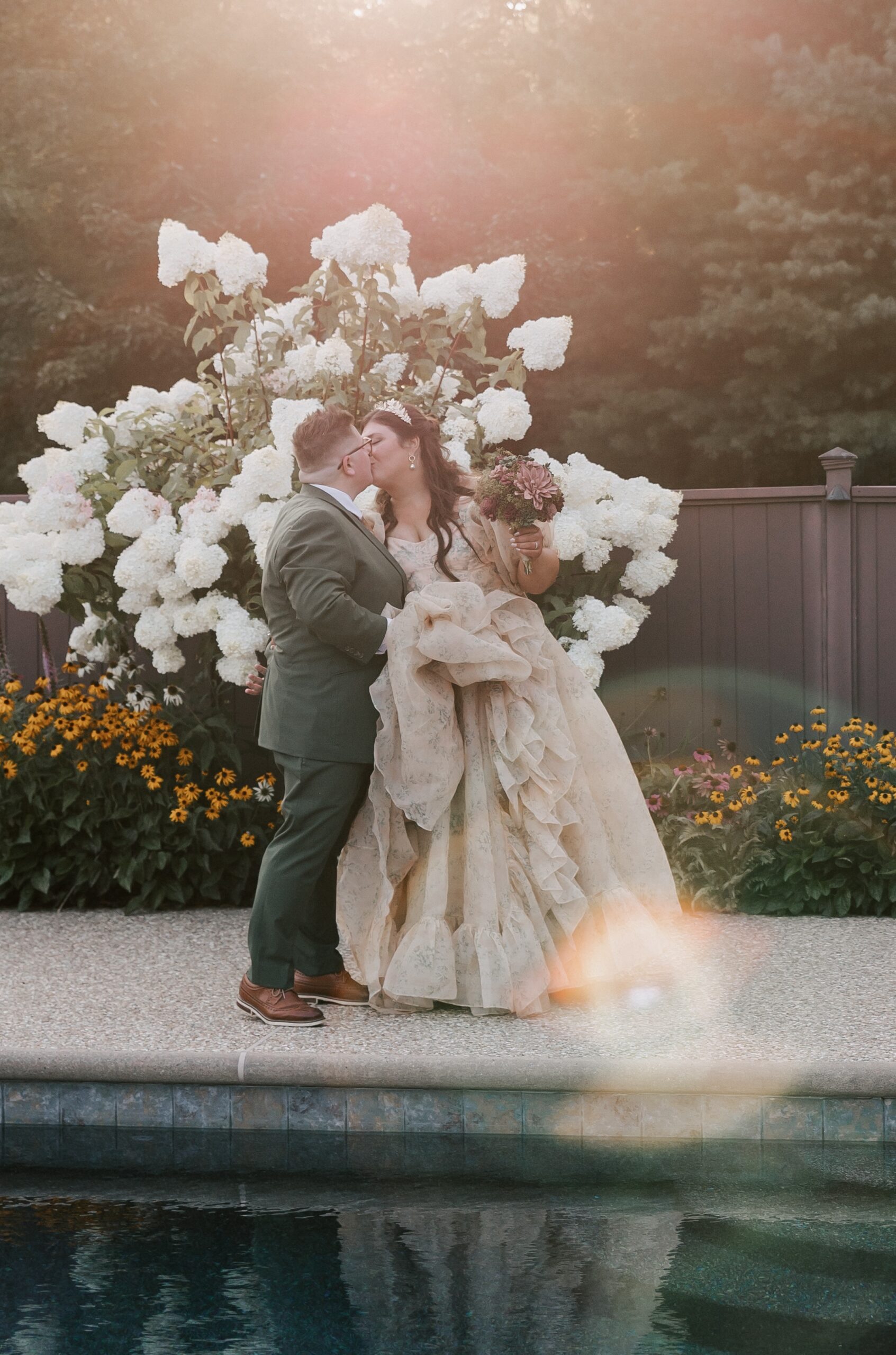 Two brides walking hand in hand by the pool at their backyard wedding in Medfield, MA